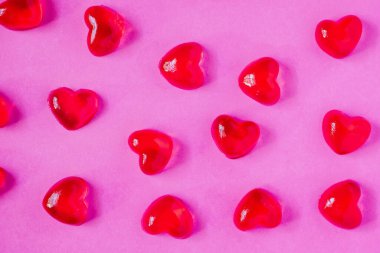 Sevgililer Günü geçmişi, pembe arka planda kalp şeklinde şekerler.