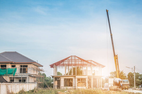 House building at construction site with crane truck