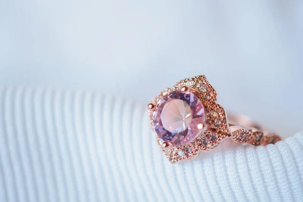 ホワイト生地の背景に豪華なピンクゴールドのサファイヤの宝石のリング — ストック写真