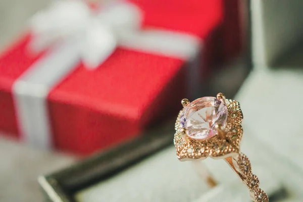 jewelry pink diamond ring with red gift box background