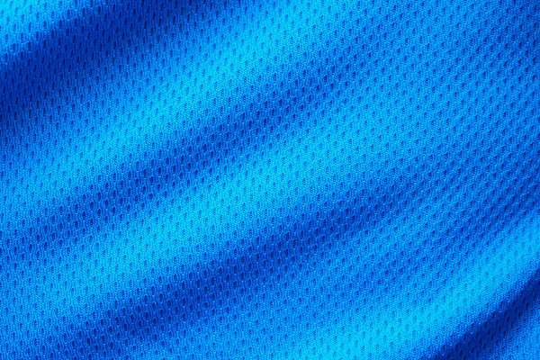 Blue fabric sport clothing football jersey with air mesh texture background