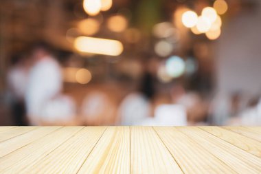 Ahşap masa üstü ve soyut Bokeh ışıkları olan kafe restoranı ürün gösterimi için bulanık arkaplan