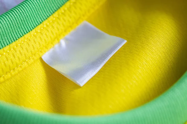 clothes label on sport textile football shirt background