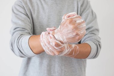 Erkek, COVID-19 Corona virüs önleme konsepti için sabunla ellerini yıkıyor.