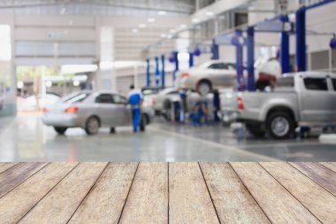 Ürünlerinizi görüntülemek ya da montajlamak için, bulanık garaj arka planlı ahşap masa üstü