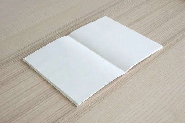 木のテーブルの背景に空白の紙の本をモックアップ — ストック写真