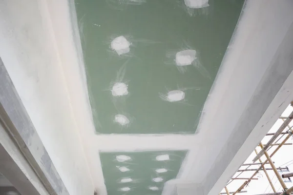 ceiling gypsum board installation at construction site