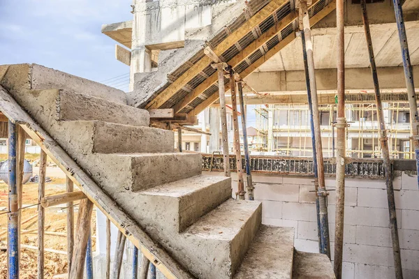 New house construction interior with concrete staircase at building site