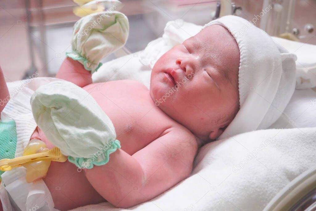 new born baby infant sleep in the incubator at hospital