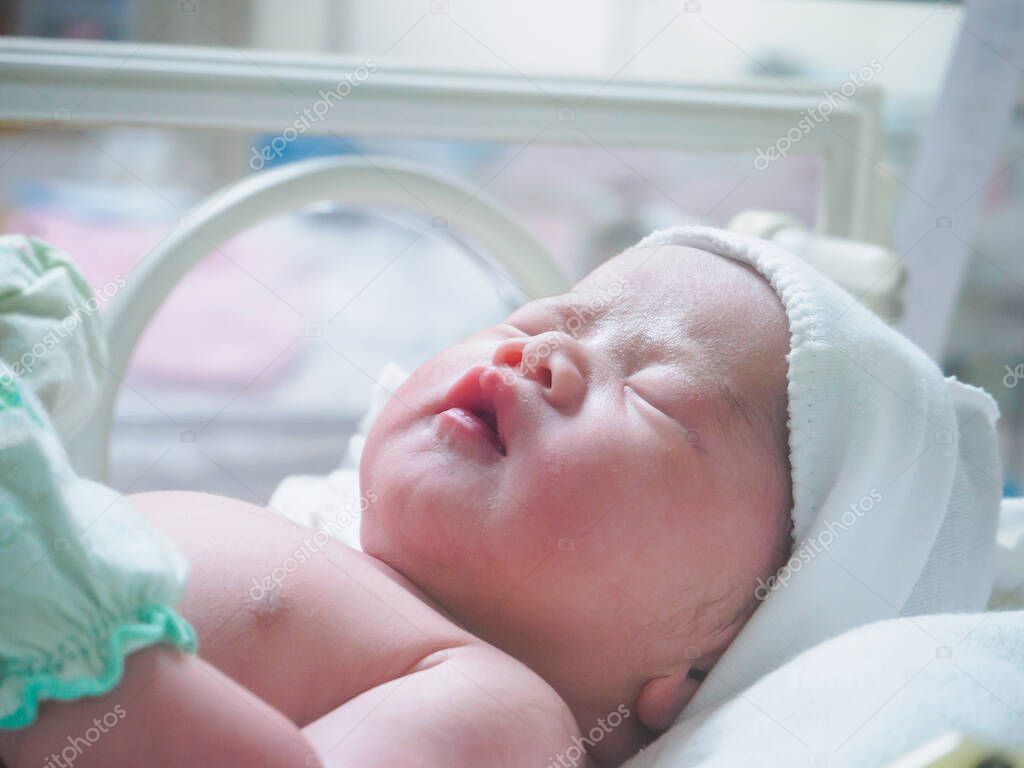 new born baby infant sleep in the incubator at hospital