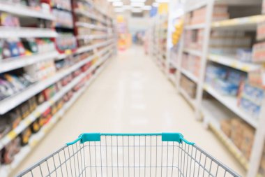 Soyut bulanık süpermarket indirim mağazası koridoru ve ürün rafları olan boş alışveriş arabası.