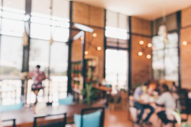 Bokeh ışıkları odaklı bulanık kafeterya restoranı.
