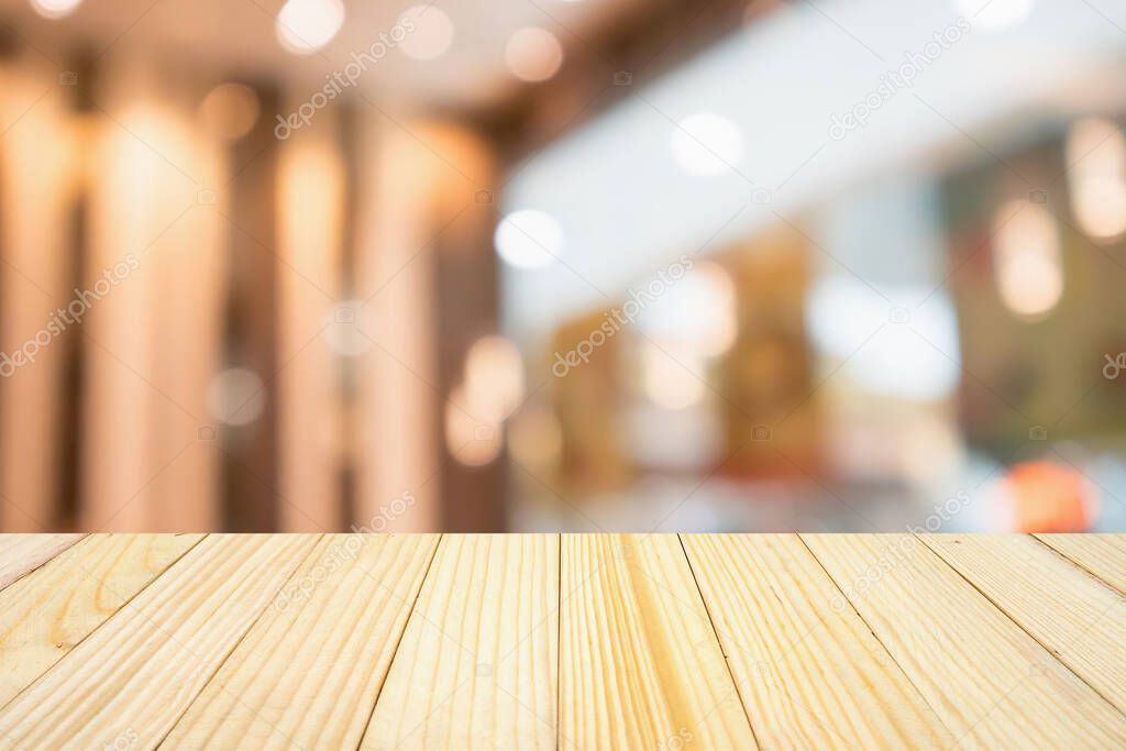wood table with abstract blurred cafe restaurant with bokeh lights defocused background