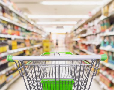 Süpermarket rafları olan boş alışveriş arabası. İç mekan bulanık arka plan.