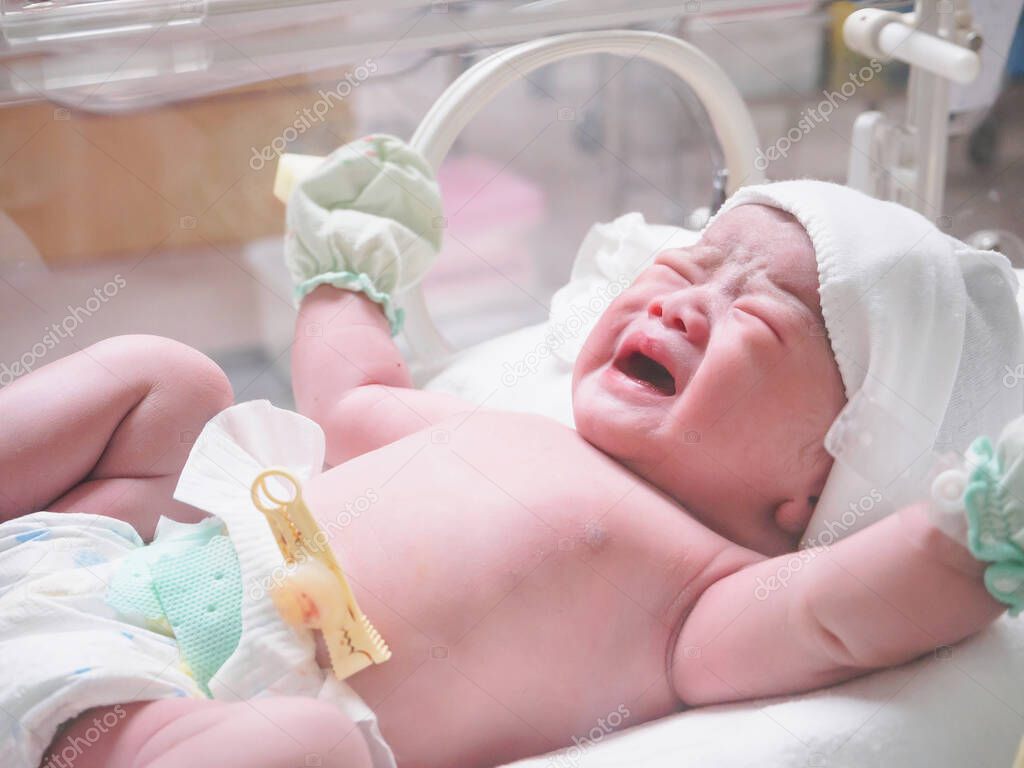 new born baby infant sleep in the incubator at hospital