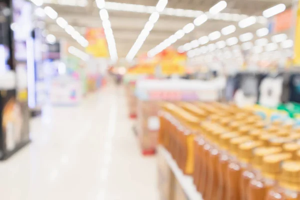 Abstract blur supermarket discount store aisle and body care product shelves interior defocused background