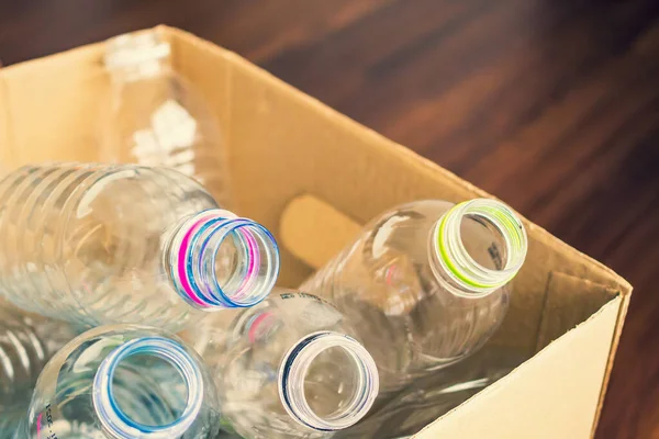 stock image plastic bottles in recycling paper box reuse concept