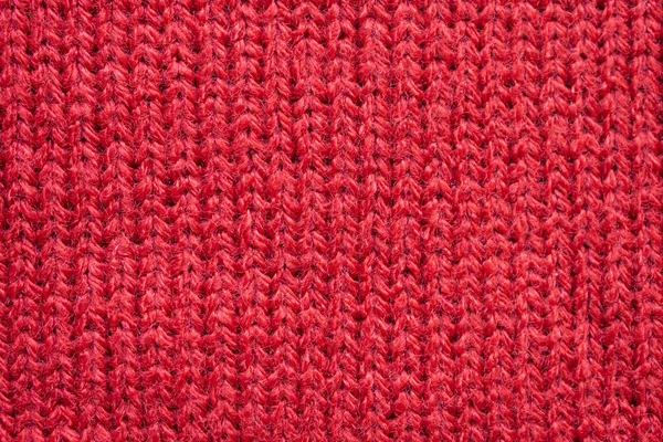 Red knitted wool fabric texture background