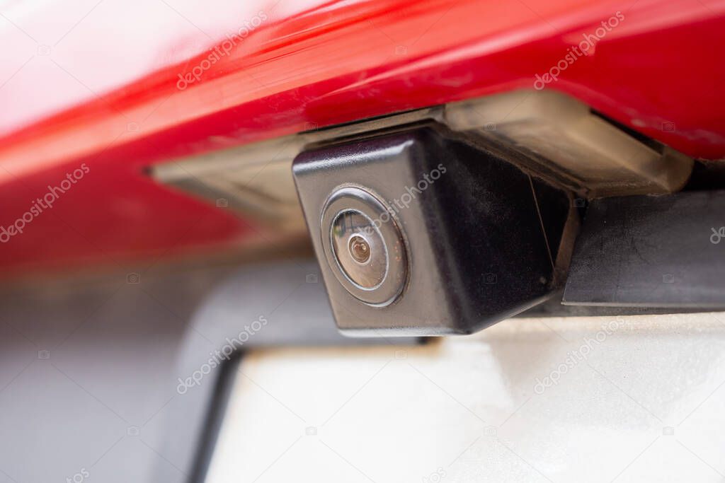 Red car rear view camera close up for parking assistance