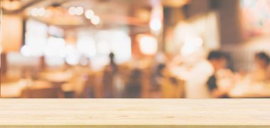 Ahşap masa üstü restoran kafesi ya da kafenin içi soyut odaklanmış bulanık arka planı olan insanlarla dolu.