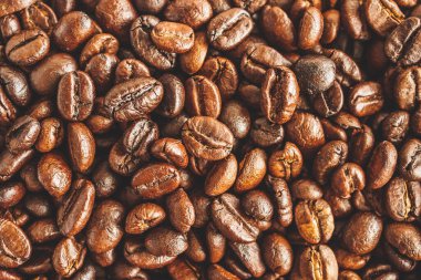 Kavrulmuş kahve çekirdekleri yakından doku arka planı.