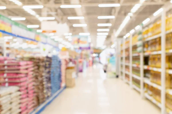 Abstract blur Supermarket aisle with rice in packaging for sale and vegetable oil bottles on shelves background