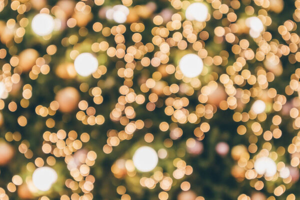 Abstract christmas holiday with festive gold bokeh light on tree blurred background