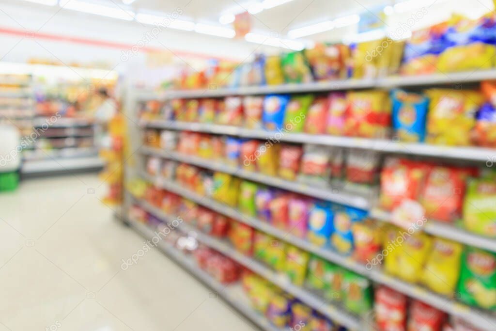 Supermarket convenience store shelves with Potato chips snack blur abstract background