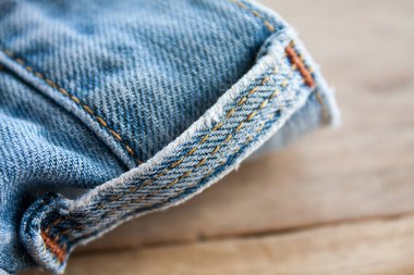 Kot pantolona yakın, ahşap zemine mavi kot kumaş.