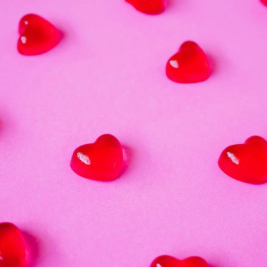 Sevgililer Günü geçmişi, pembe arka planda kalp şeklinde şekerler.