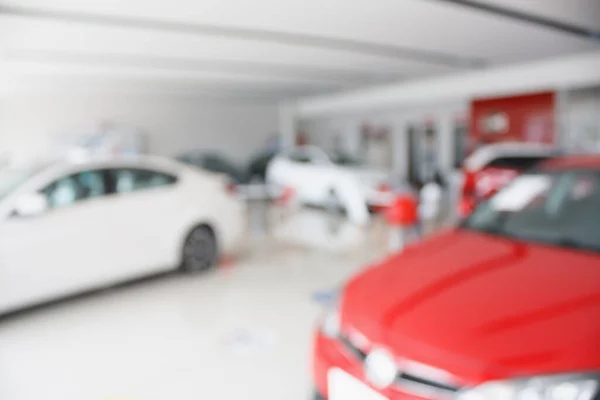 new car at new car showroom dealership blurred background