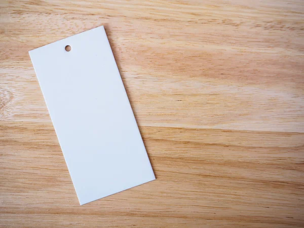 blank white price label on wood background