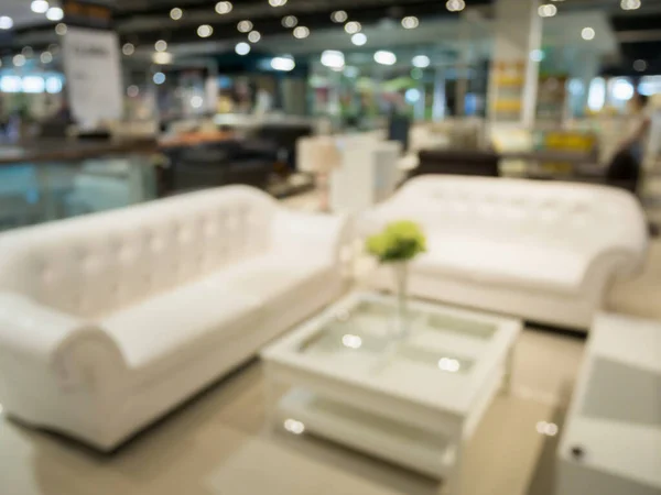 Abstract blur sofa in furniture store shop interior with bokeh light background for montage product display