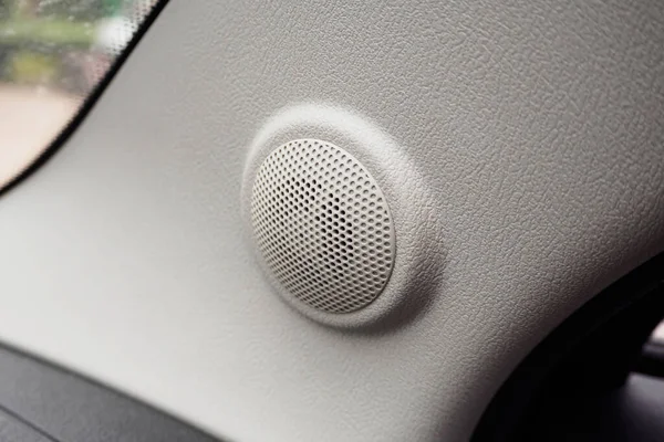 close up round speaker audio in modern car