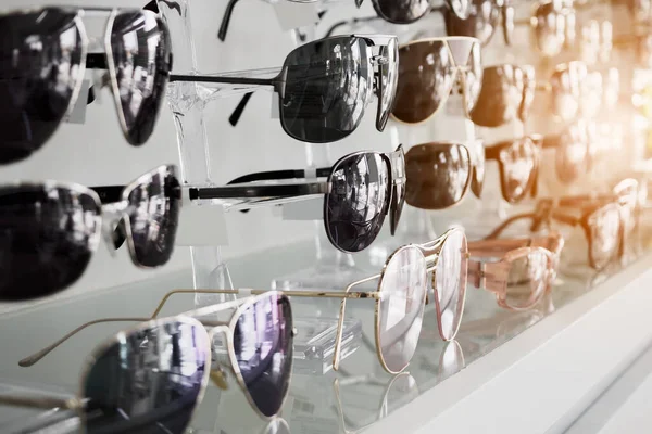 stock image Sunglasses on display shelves in glasses store