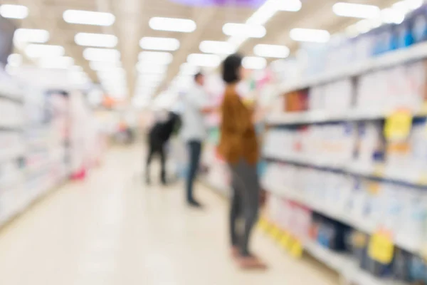 Abstract blur supermarket discount store aisle and product shelves interior defocused background