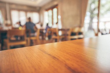 Müşteri ve ahşap masa ile restoran içi Bokeh Light ile soyut arka plan bulanıklaştırır