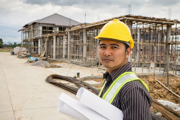 在房屋建筑工地手握防护头盔和蓝图纸的亚洲商人 建筑工程师 — 图库照片