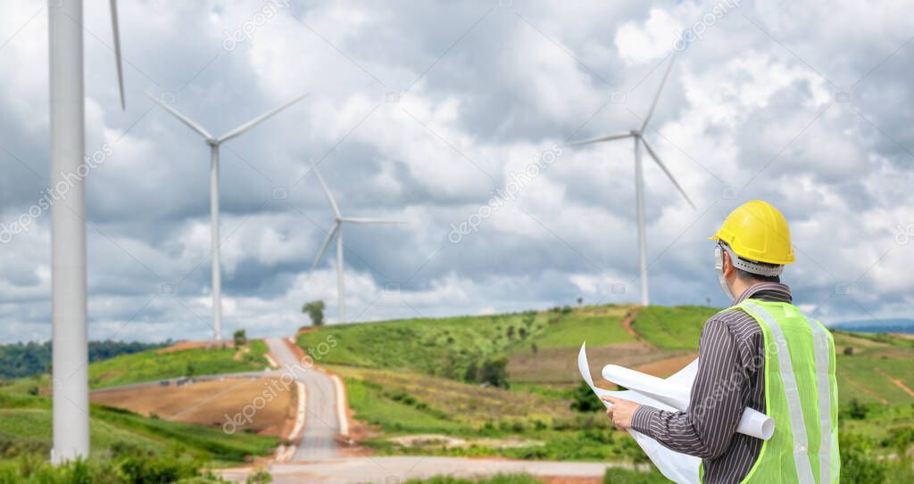 Engineer worker at wind turbine power station construction site