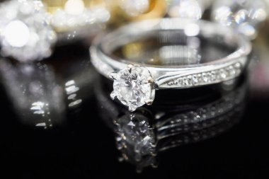 Siyah arka planda yansıması olan lüks mücevher yüzükleri.