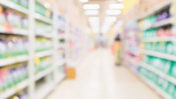 Abstract blur supermarket discount store aisle and product shelves interior defocused background