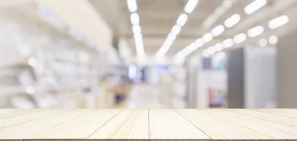 wood table top with eletronic department store in supermarket shopping mall show Television TV refrigerator and home appliance with bokeh light blurred background for product display