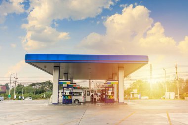 Petrol gas fuel station with clouds and blue sky clipart