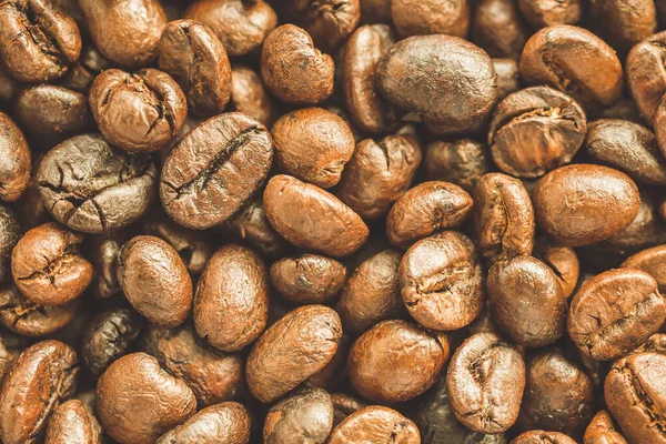 Kavrulmuş kahve çekirdekleri yakından doku arka planı.