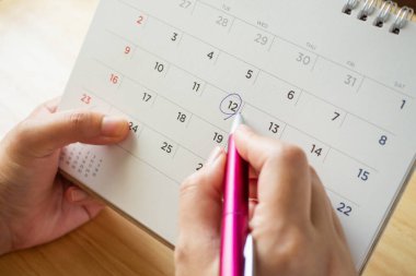 Masada kadın eli kalem tutan takvim sayfası