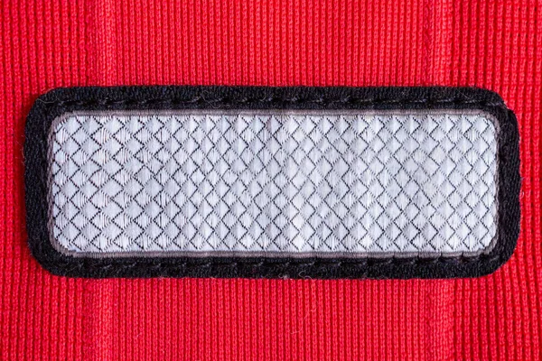 Kırmızı Polyester Spor Forma Desenli Arka Planda Boş Kıyafet Etiketi — Stok fotoğraf