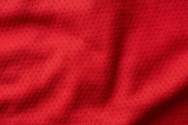 Red fabric sport clothing football jersey with air mesh texture background