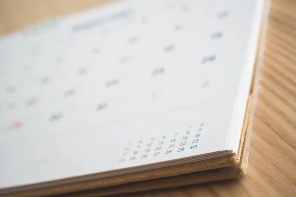 calendar page on wood table background
