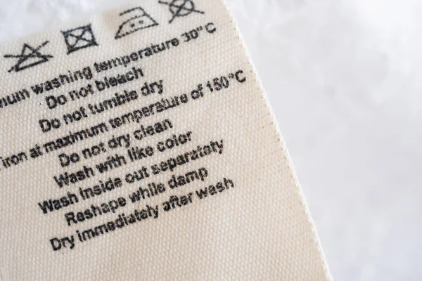 Cuidado Ropa Instrucciones Lavado Etiqueta Ropa Tela Textura Fondo — Foto de Stock