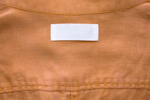 Etiqueta Etiqueta Ropa Blanca Blanco Sobre Fondo Textura Camisa Lino — Foto de Stock